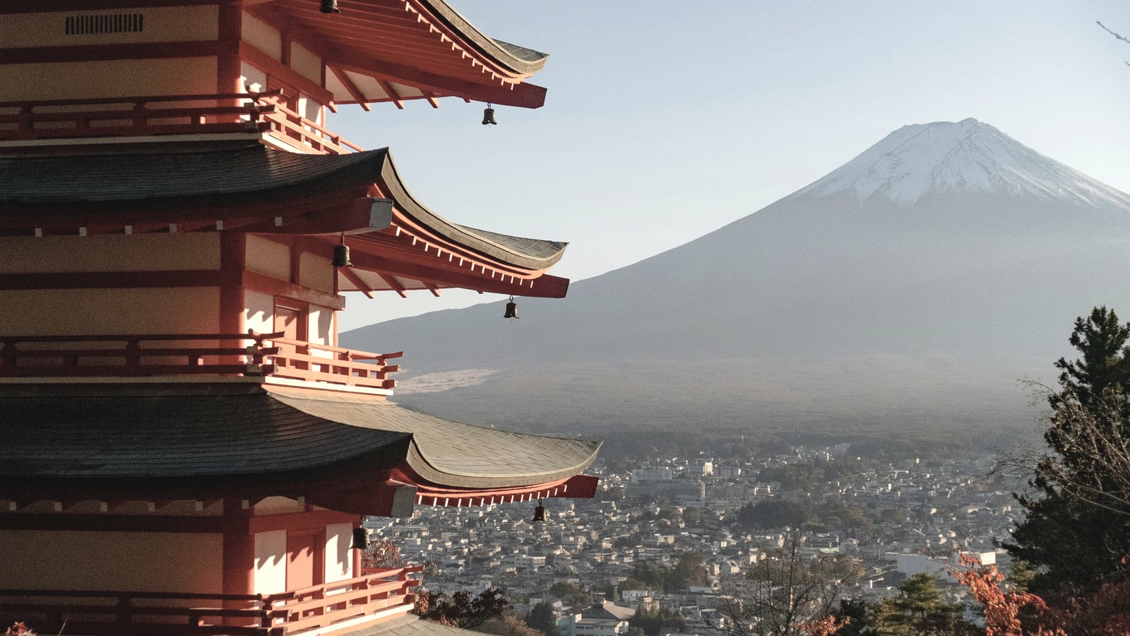 Mount Fuji and a pagoda above a town landscape